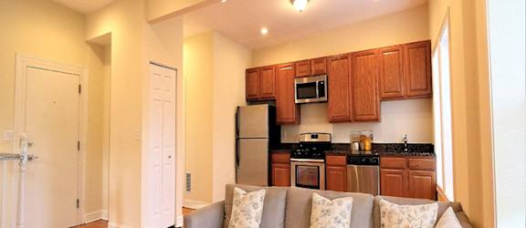a living room with a couch and a kitchen