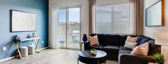 a living room with a blue accent wall and a couch