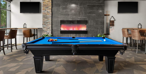 a games room with a pool table and a fireplace