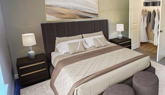A bedroom with a large bed and a ceiling fan.
