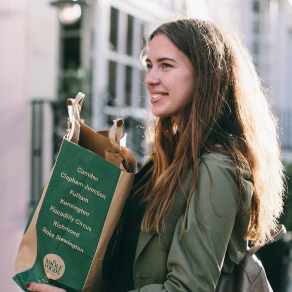 woman holding shopping bag at Woodland Village Apartments , Woodland California