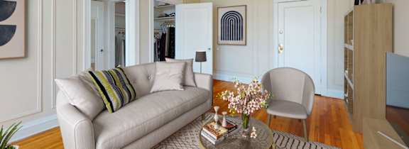 A living room with a couch, chair, and a coffee table.