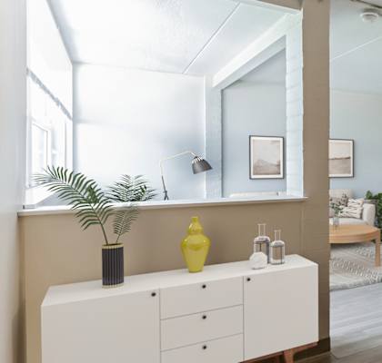 a bedroom with a large mirror and a white dresser