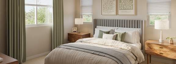 Bedroom with green curtains and large windows