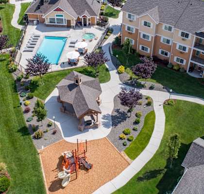 an aerial view of a neighborhood with houses and a swimming pool