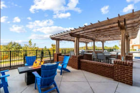 a patio with a fireplace and a pergola