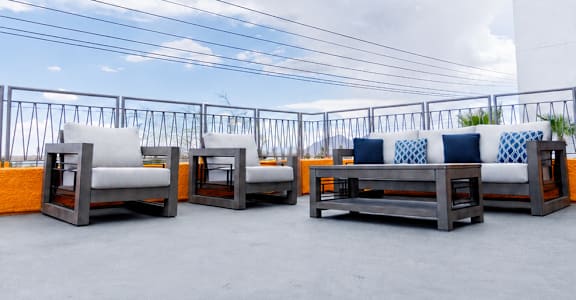 A set of outdoor furniture is arranged on a rooftop.