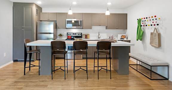 A kitchen with a table and chairs in the middle of it. at Quail Ridge, Plainsboro Township, NJ, 08536