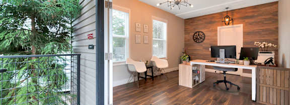 A home office with a desk and chairs is shown.