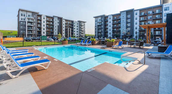 Pool With Lounge Chairs at G17 Apartments at Tamarack, Edmonton