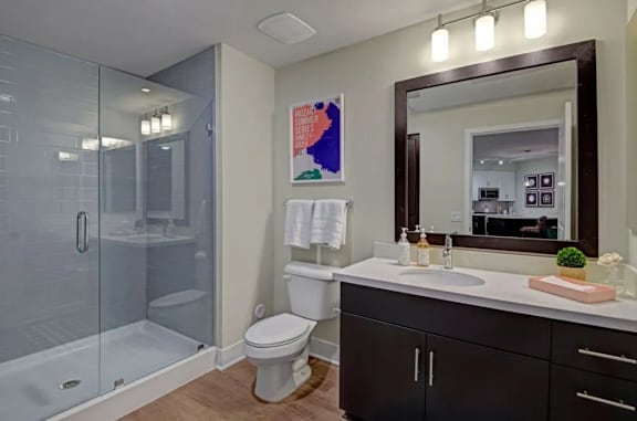 A bathroom with a toilet, sink, and shower.