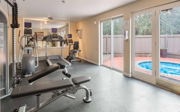 a gym with weights and a pool in the corner at Quartz Creek, Washington, 98043