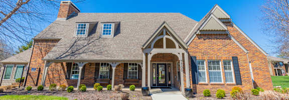 A house with a brick facade and a grey roof.