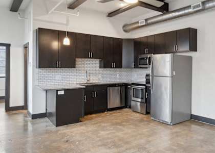 A kitchen with a refrigerator, stove, and oven.