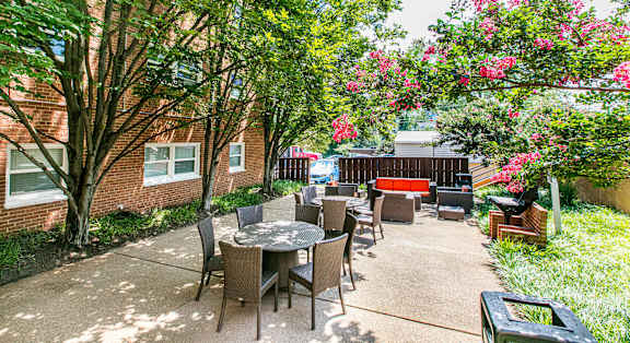 A large room with a blue couch and a chandelier. at Park Georgetown Apartments, Arlington