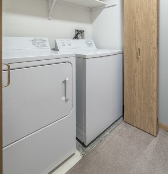 Full-size washer and dryer in a laundry closet at Fountain Glen Apartments in Lincoln, NE.