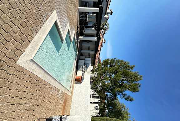 a view of a kiddie pool and sitting area at The Bryant Apartments at Yorba Linda, Yorba Linda