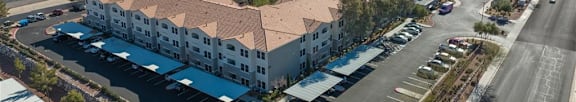 A swimming pool in front of apartment buildings.
