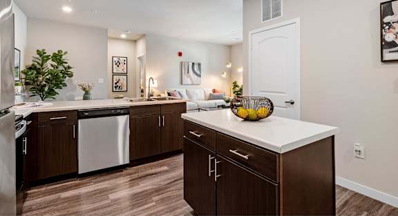 A kitchen with brown cabinets and a white countertop.