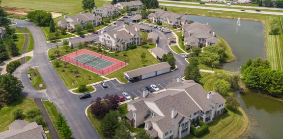 an aerial view of a neighborhood with houses and a tennis court