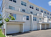 Thumbnail 36 of 43 - a street view of an apartment building with a car parked in front