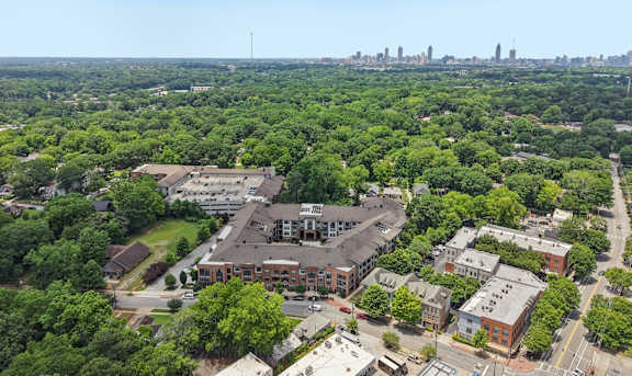 A bird's eye view of a city with a large green area in the foreground.