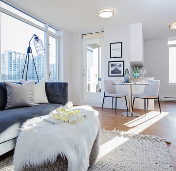 Open concept apartment with large windows at Wesley Place apartments in Vancouver, British Columbia