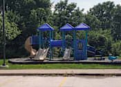 Thumbnail 5 of 5 - a playground with a slide and swings and a duck