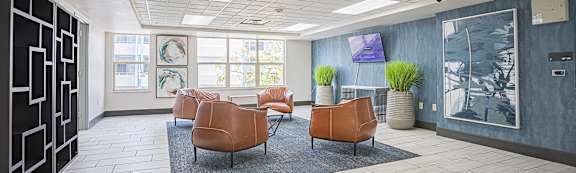 a large lobby with leather chairs and a rug at ParcOne60, Reno, 89501