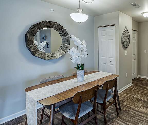 A dining room with a wooden table and chairs at Abbey Ridge Apartment Homes, Oxford, MI, Michigan
