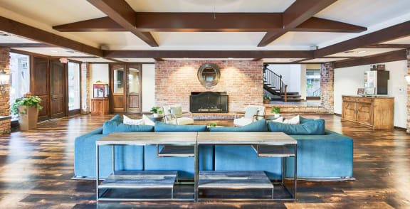 a living room with a blue couch and a table at The Meadows Apartments, Culver City , CA 90230