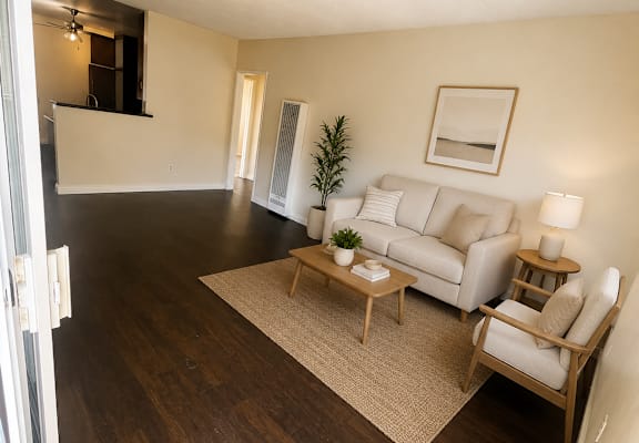 A living room with a couch, chair, and coffee table.