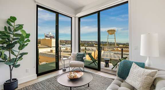 a living room with a couch and a coffee table and a view of the cityat WM by CLG, Los Angeles, 90232