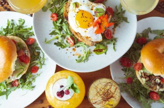 a plate of food with an egg on top of a salad
