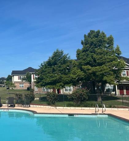 a swimming pool with houses in the background