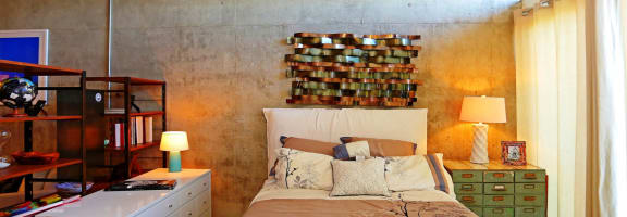 a bedroom with a bed and a book shelf on the wall  at 1221 Broadway Lofts, San Antonio, Texas