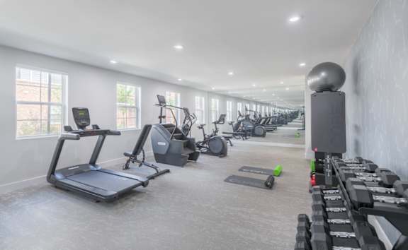 A spacious home gym with a variety of exercise equipment.
