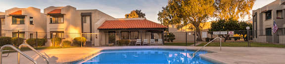 Riverstone pool view with nice view, and lounging area nearby