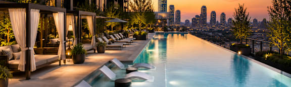 A long pool with a city skyline in the background.