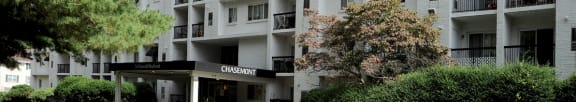 a large apartment building with cars parked in front of it