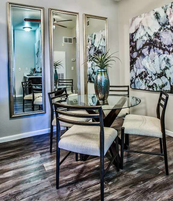 A dining room with a table and chairs.