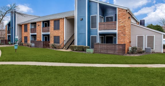 our apartments at the overlook feature a green lawn and blue skies