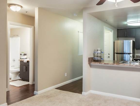 Living room and a kitchen with a ceiling fan at Ascend2300, 92008