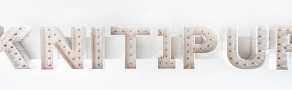 the word krypton spelled out in a row of studs in the snow