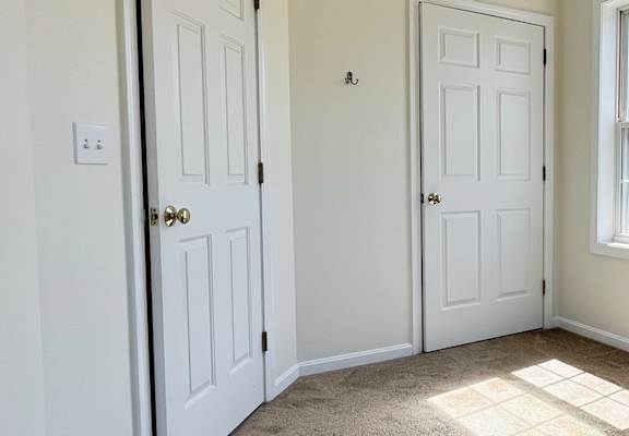 A room with two doors and a window.