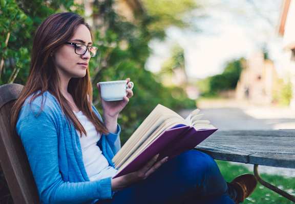 Olive Grove Apartments Woman Reading a Book