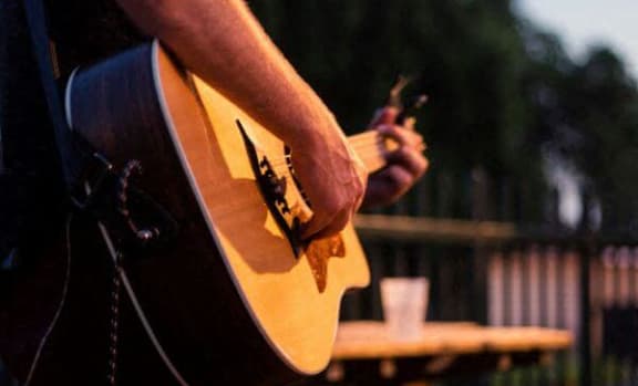 a person is holding a guitar
