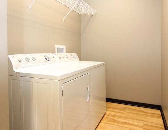 A white washing machine and dryer in a laundry room.