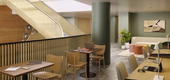 a restaurant with tables and chairs and a staircase