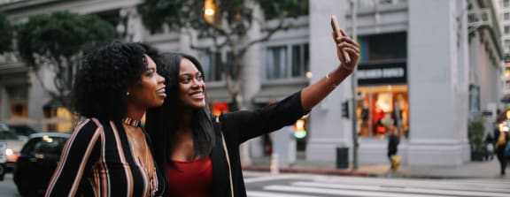 two woman in downtown los angeles taking a selfie